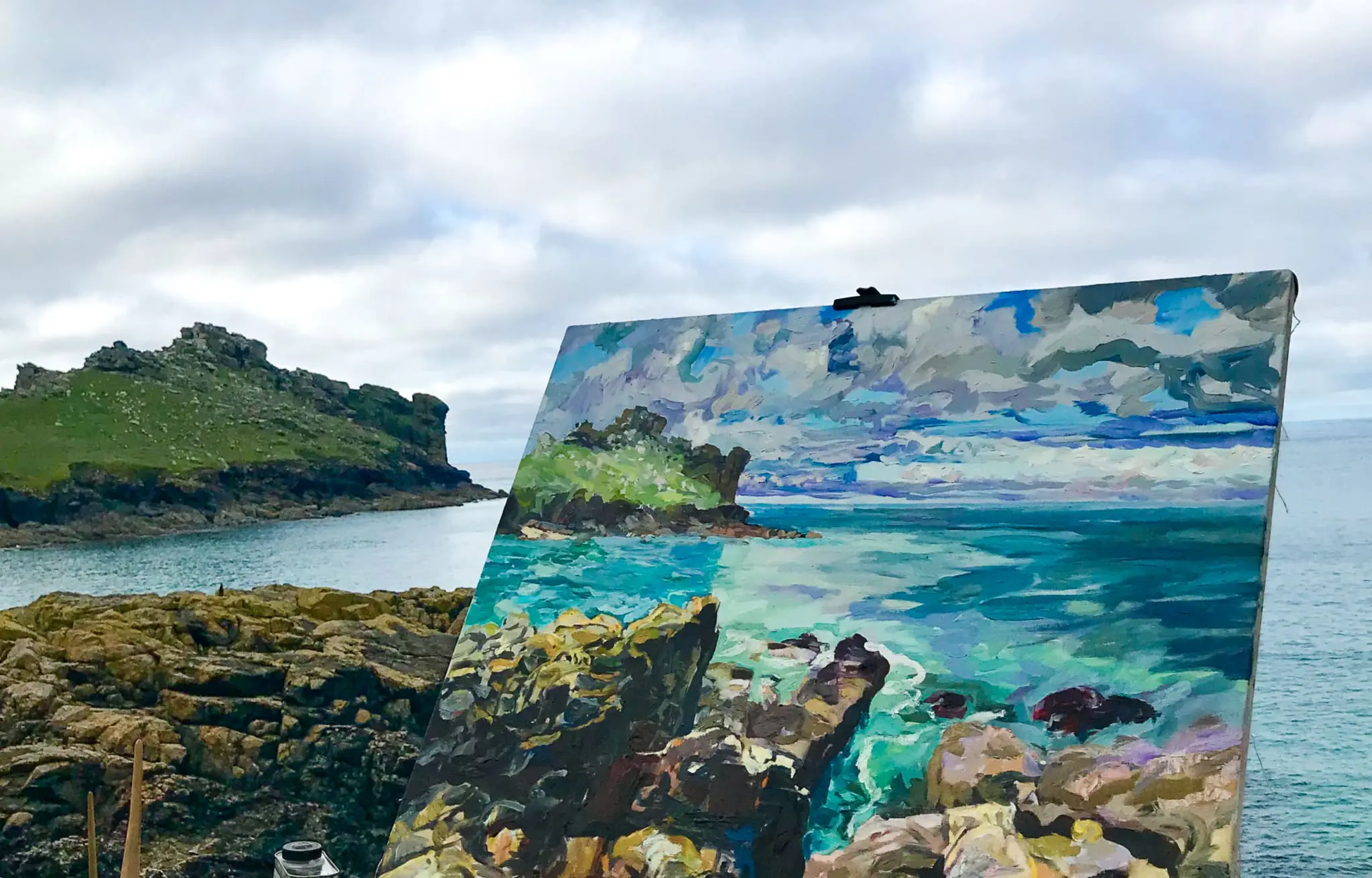 George Irvine painting costal scene of rocks